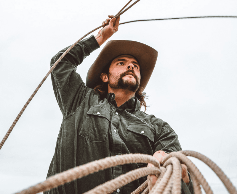 Man in black shirt roping